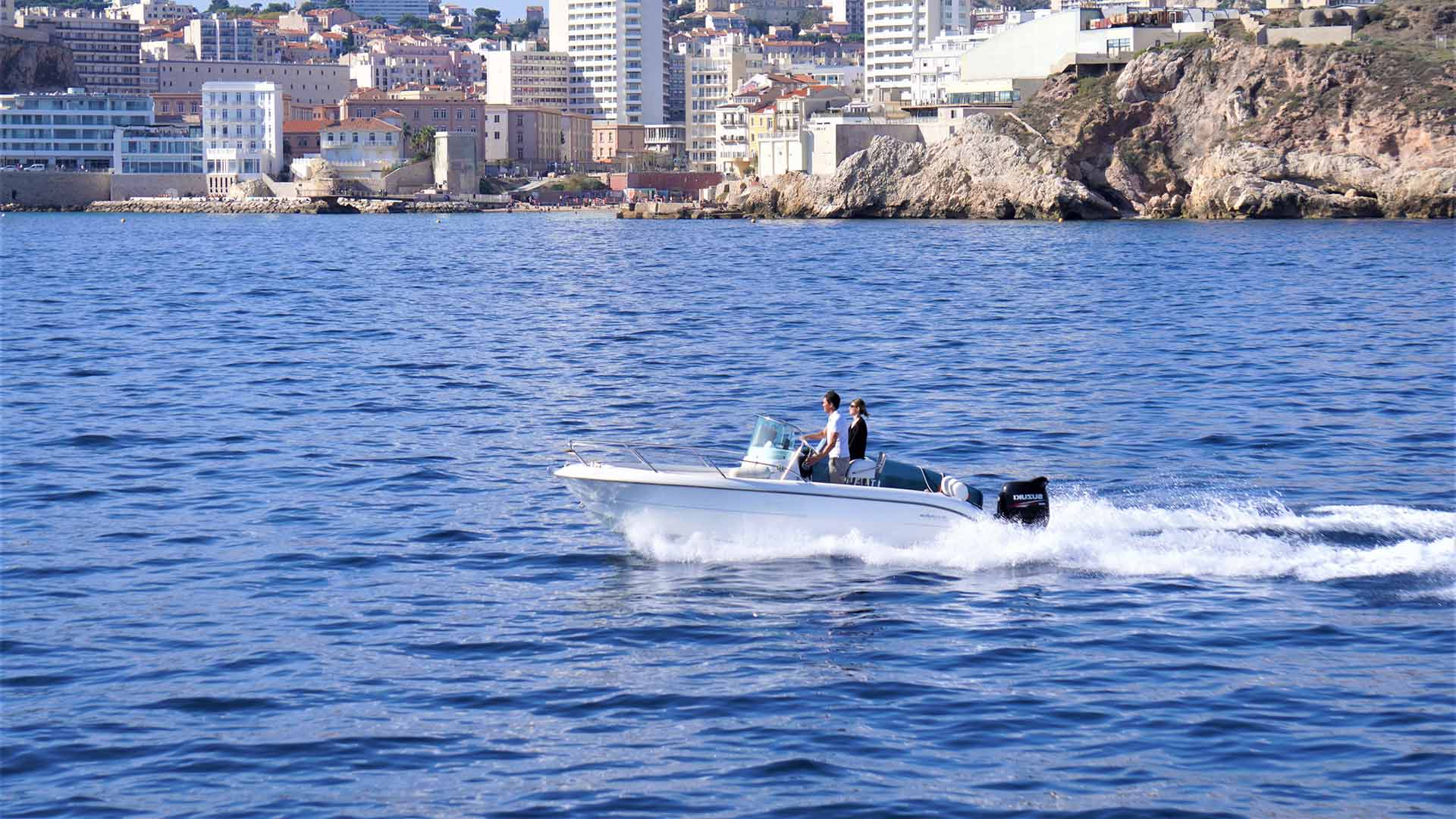 Couple riding a speed boat